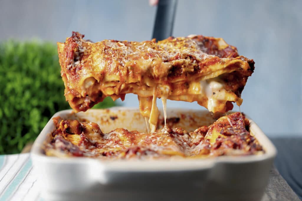 A slice of lasagna on a spatula.