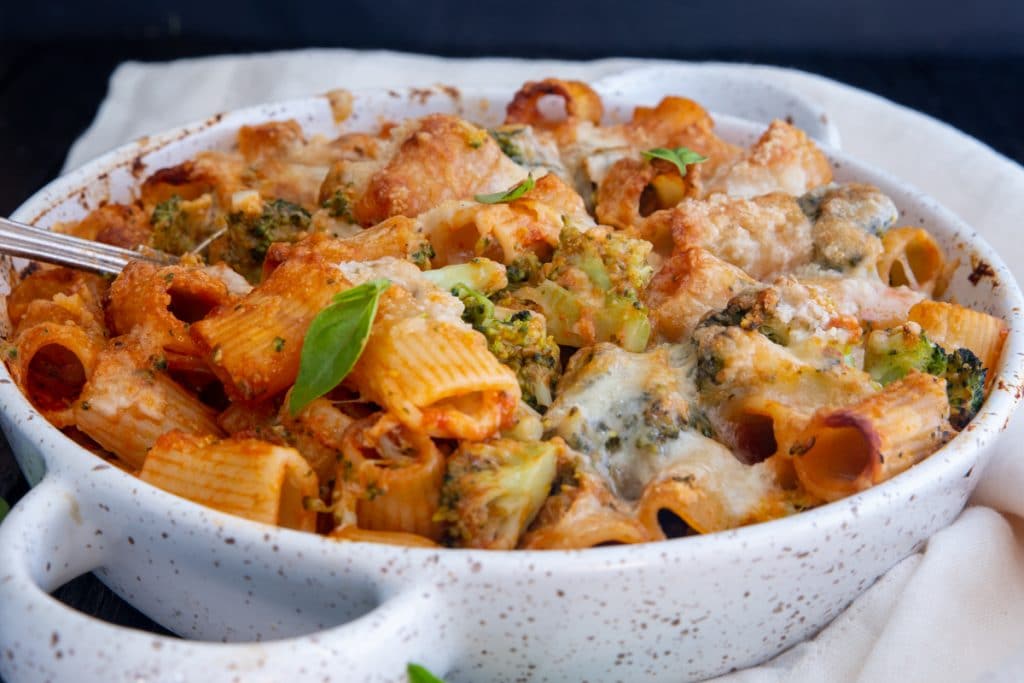 Broccoli bake pasta in a white pan.