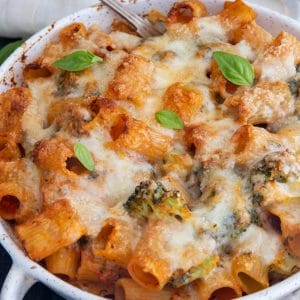 Broccoli pasta in a white pan with a silver spoon.