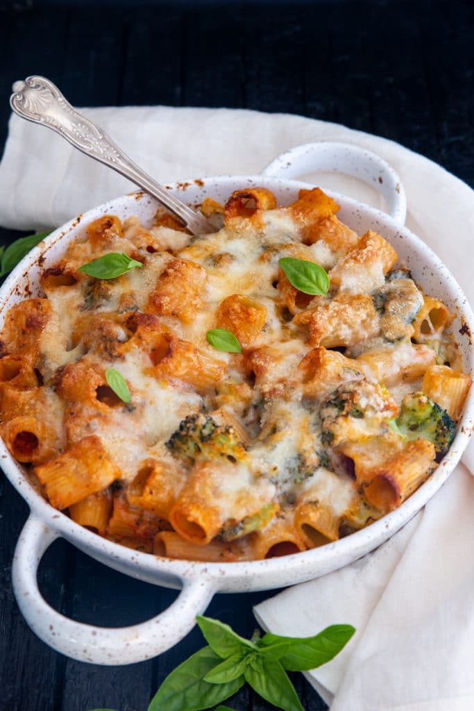 Broccoli pasta in a white pan with a silver spoon.