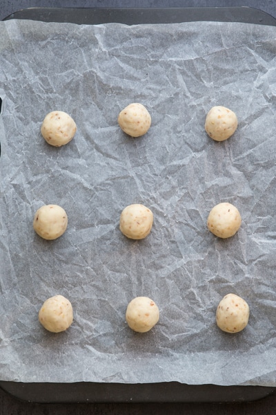 forming small balls of snowball cookies before baking