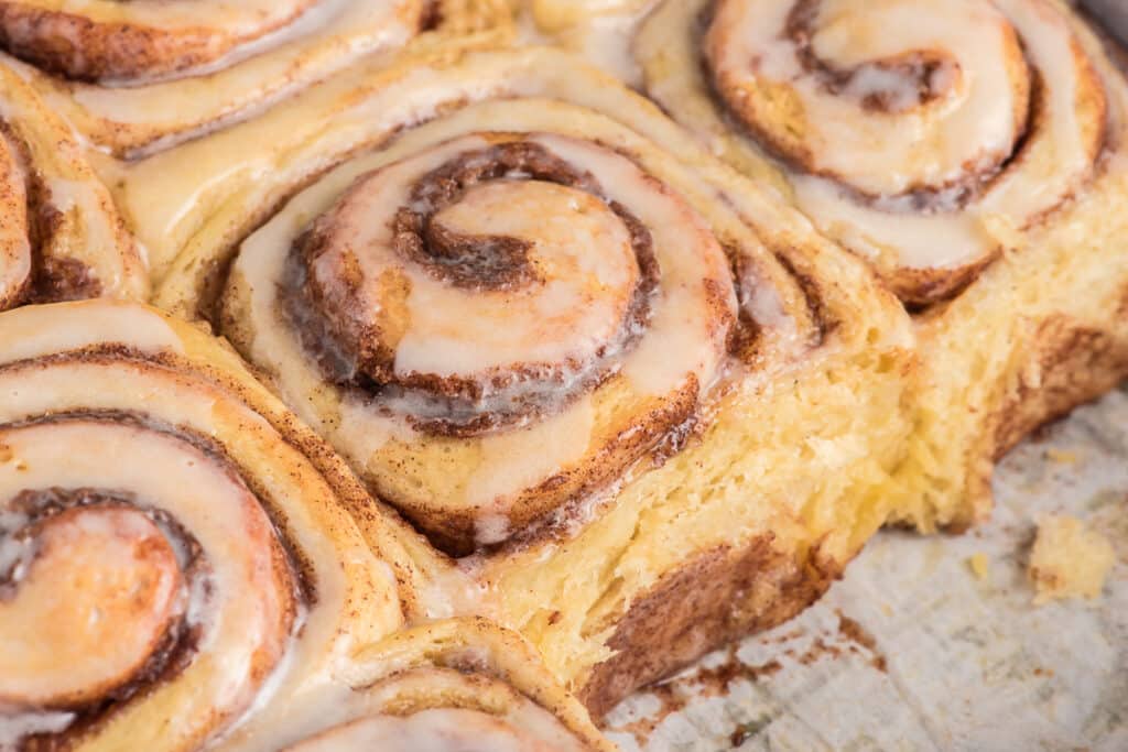 Cinnamon buns up close in the pan.
