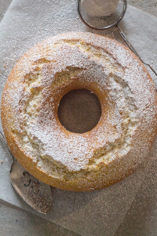 lemon cake on a white board sprinkled with powdered sugar