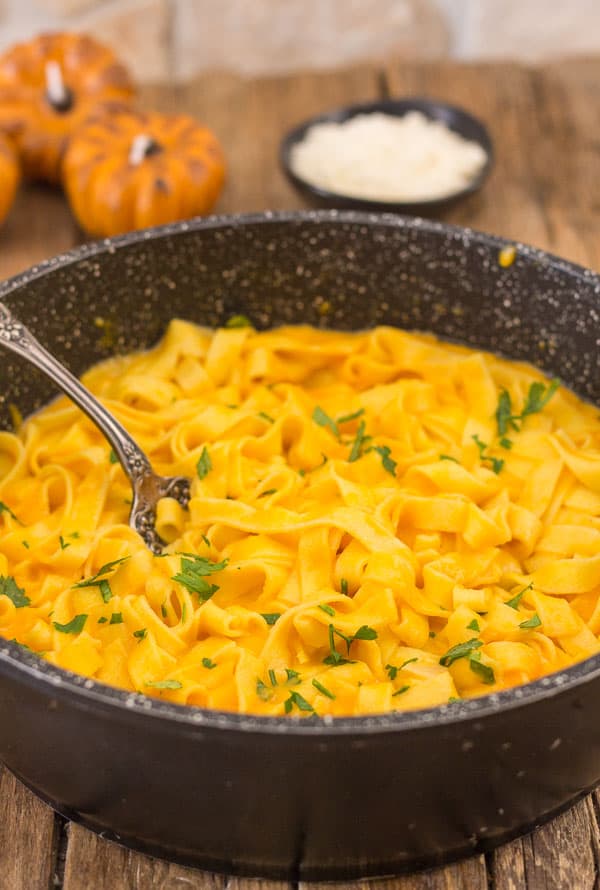 creamy pumpkin pasta sauce in a pot with a fork