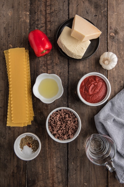 Ingredients for lasagna cups on a board.