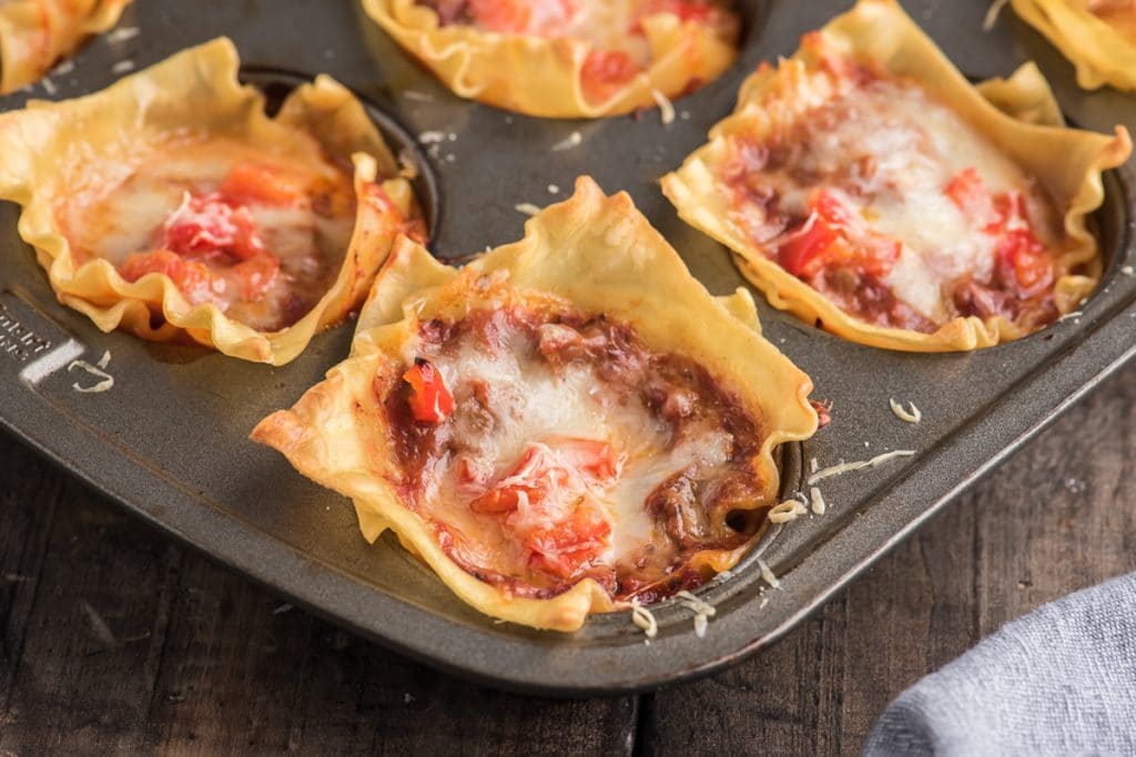 Lasgna cups in the muffin tin.