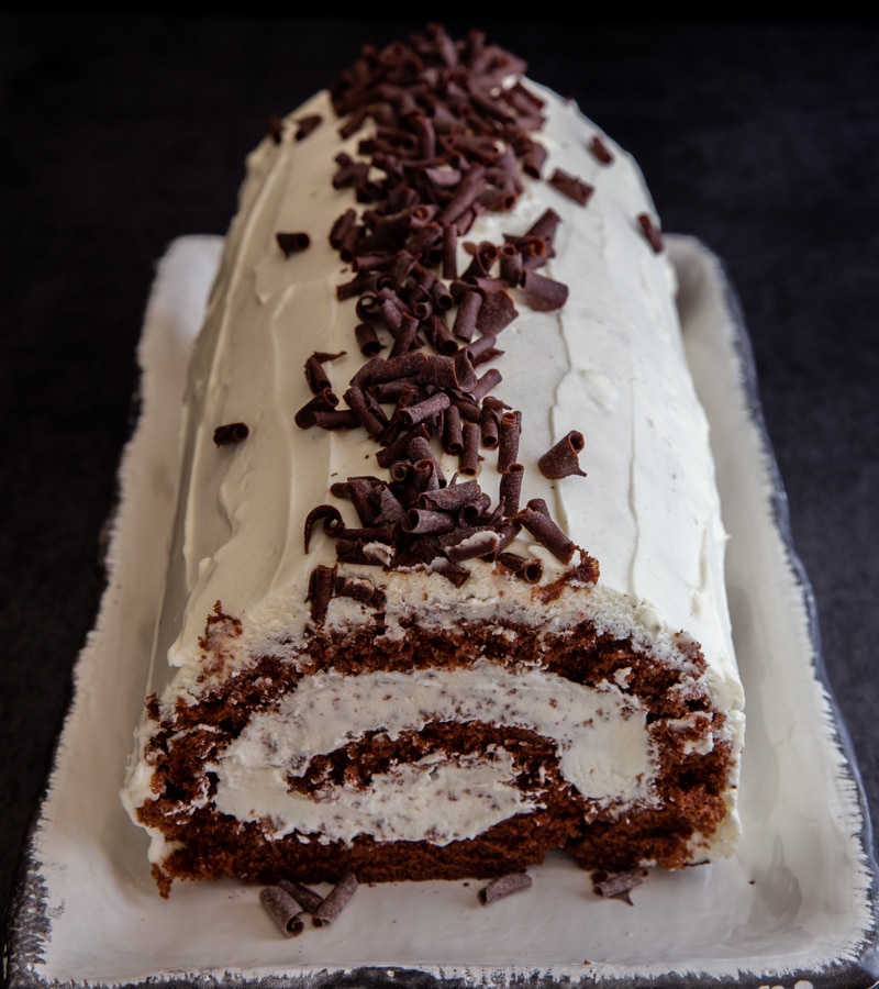 tiramisu roll cake on a white plate