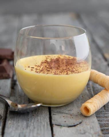 Zabaione in a glass with grated chocolate on top.