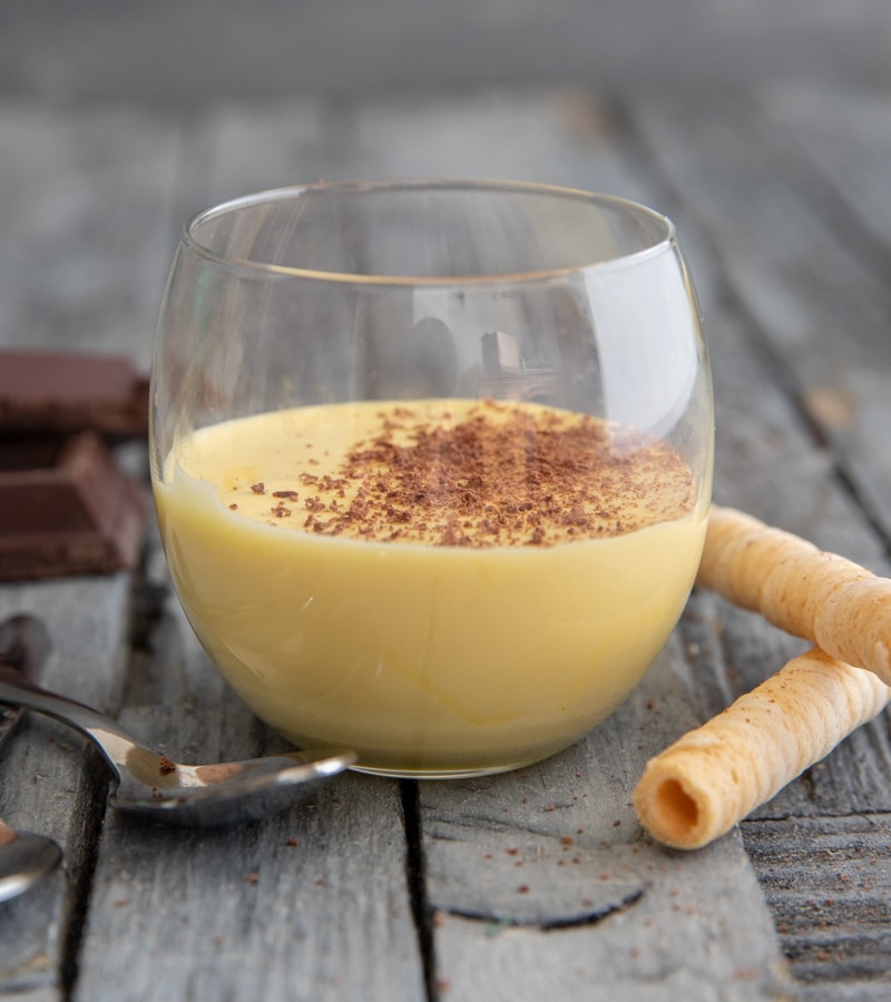 Zabaione in a glass with grated chocolate on top.