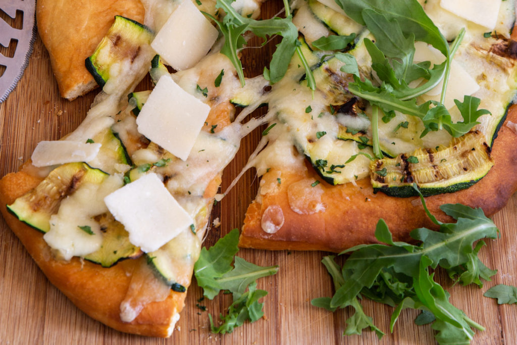 A slice of grilled zucchini pizza.