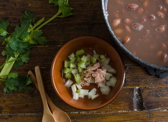 chopped celery, onions and tuna in a small brown bowl