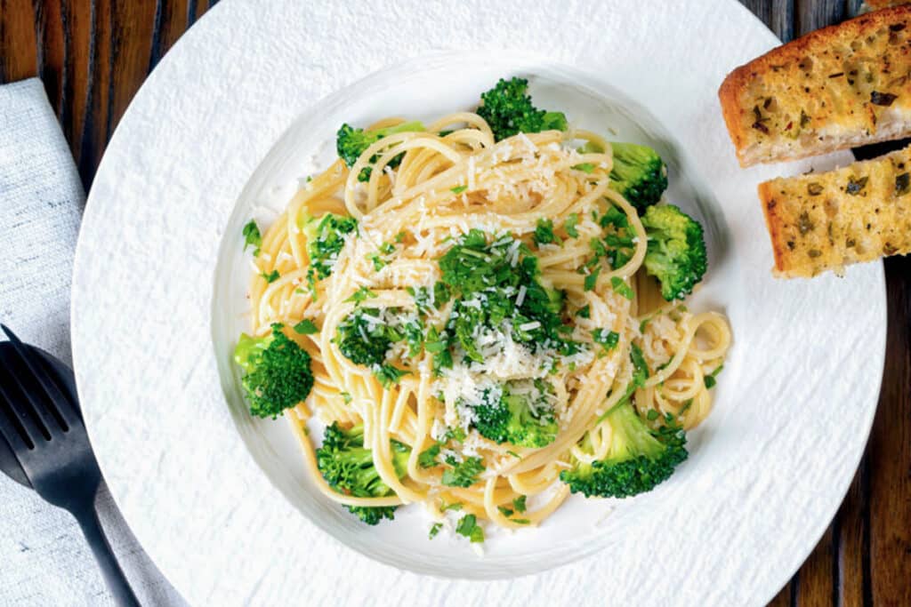 Broccoli pasta on a white plate.