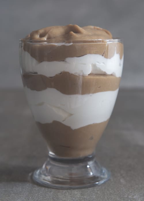 Five layers of cappuccino parfait in a glass.