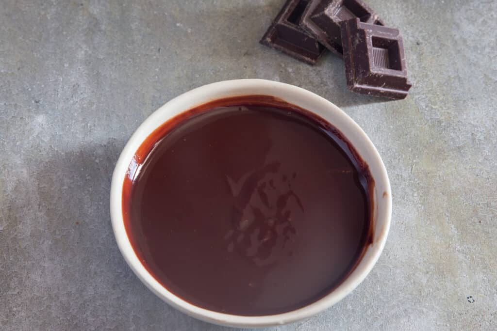 Chocolate glaze in a white bowl.