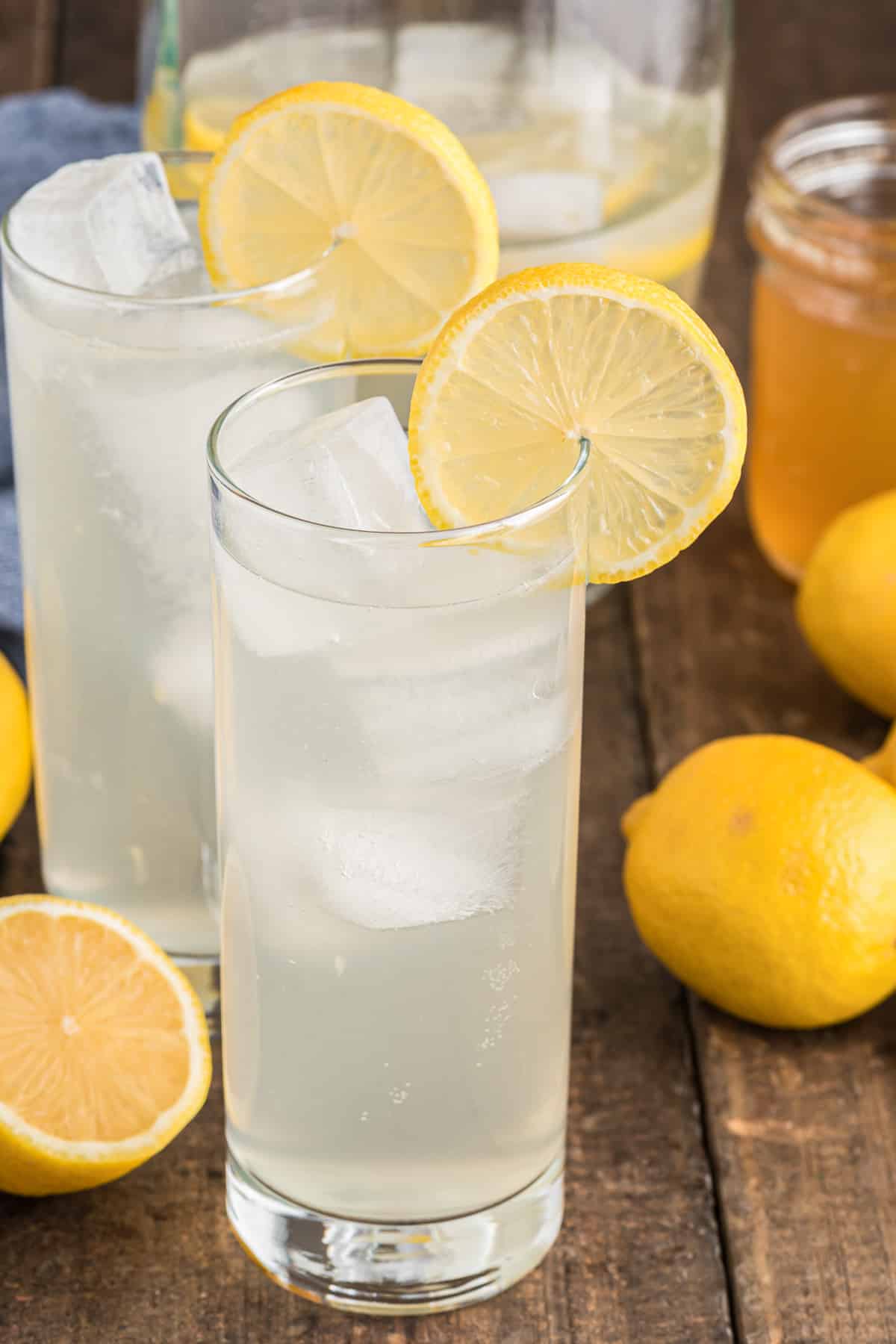 Two glasses with lemon syrup drink in them.