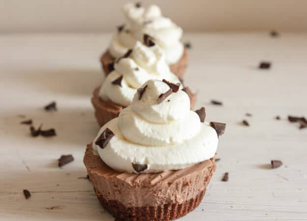 Mini chocolate frozen pies on a white board.