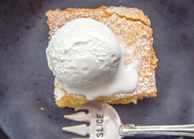 top view of peach filled Italian crostata bars on a plate with ice cream