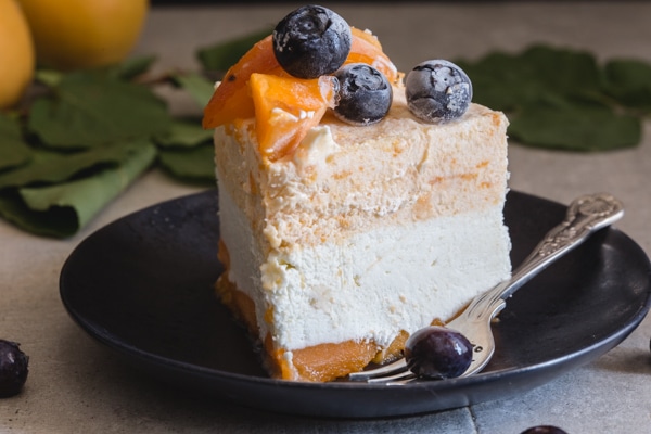 slice of apricot cake on a black plate