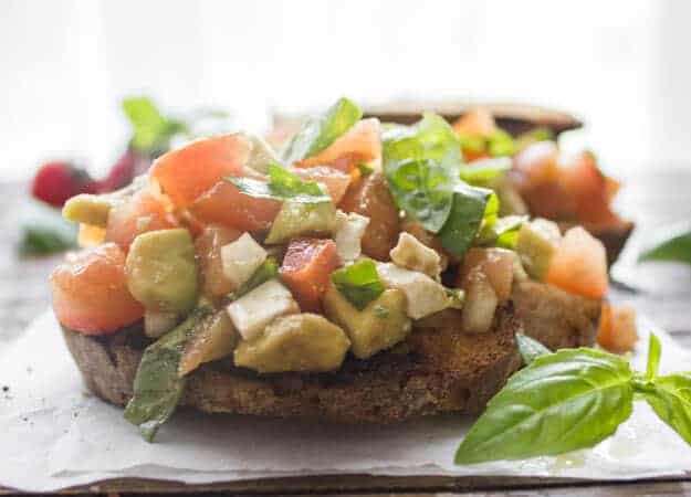 Easy Tomato Avocado Feta Bruschetta a simple & fast appetizer. Fresh ingredients, olive oil and balsamic make this a delicious healthy recipe .