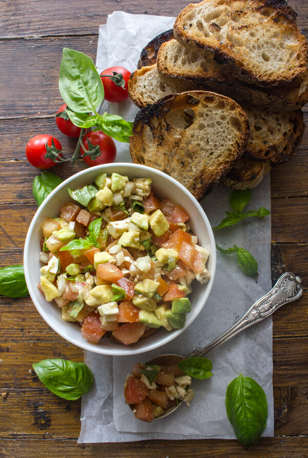 Easy Tomato Avocado Feta Bruschetta a simple & fast appetizer. Fresh ingredients, olive oil and balsamic make this a delicious healthy recipe .