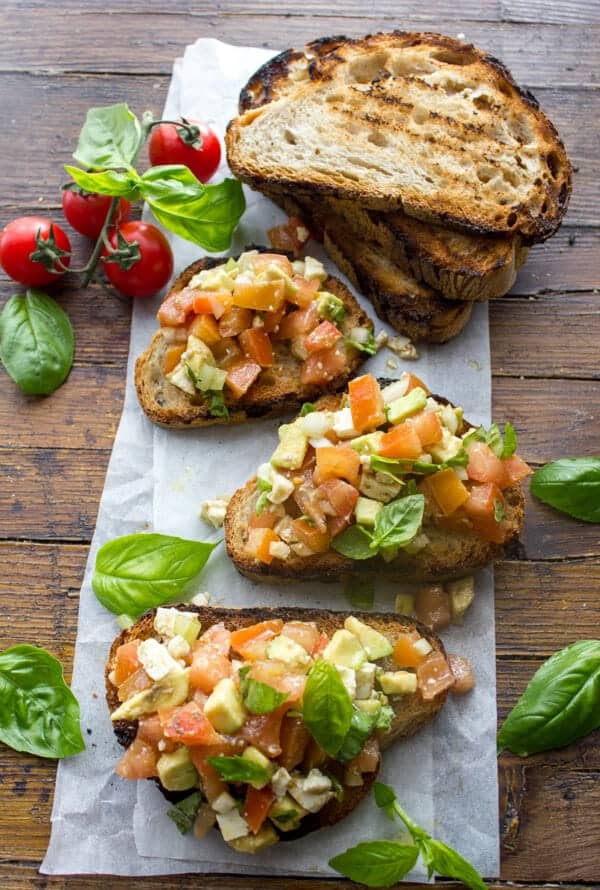 Easy Tomato Avocado Feta Bruschetta a simple & fast appetizer. Fresh ingredients, olive oil and balsamic make this a delicious healthy recipe .