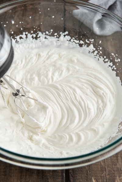 Beating the whipping cream.