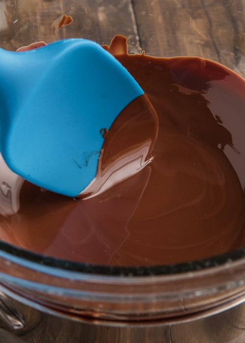 The melted chocolate in a glass bowl.