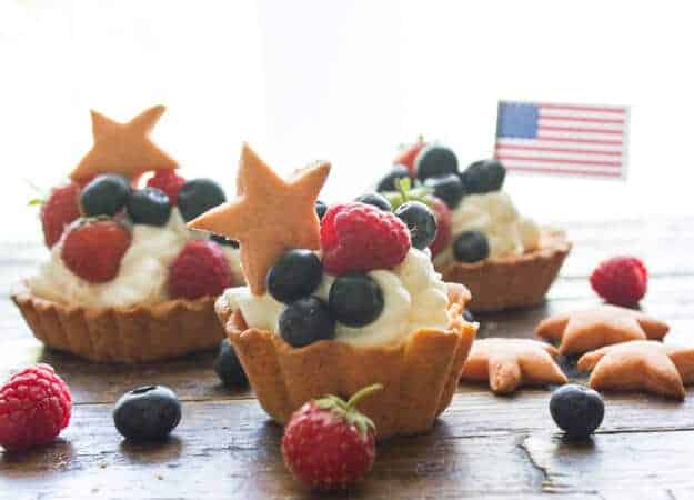 Creamy Filled Patriotic Fruit Tarts, a flaky pastry crust, filled with a creamy Mascarpone/cream cheese filling, an easy dessert recipe.