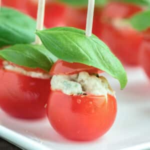 Stuffed tomatoes on a white plate.