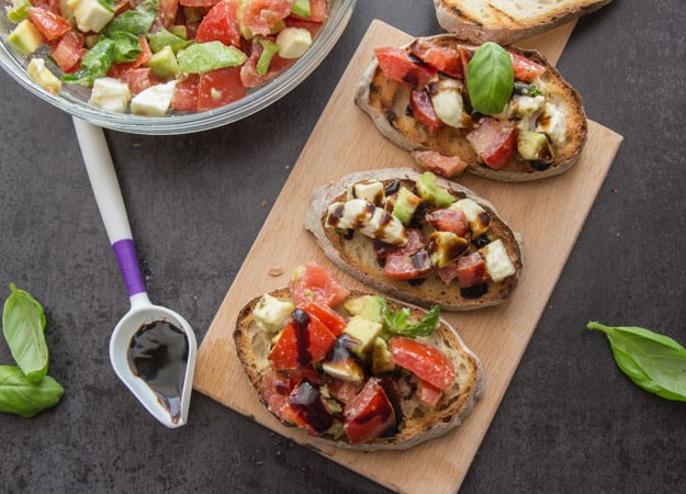 Easy Tomato Avocado Feta Bruschetta a simple & fast appetizer. Fresh ingredients, olive oil and balsamic make this a delicious healthy recipe.