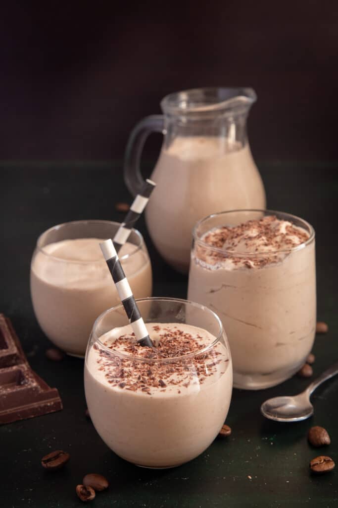 Baileys iced coffee in a jug and three glasses.