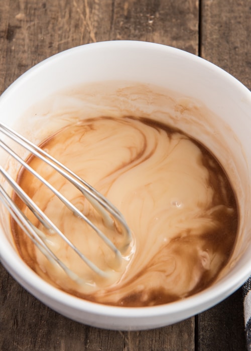 Mixing the sweetened condensed milk and vanilla.