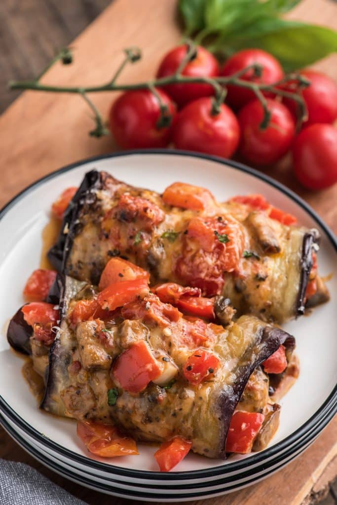 2 stuffed eggplants on a white plate.