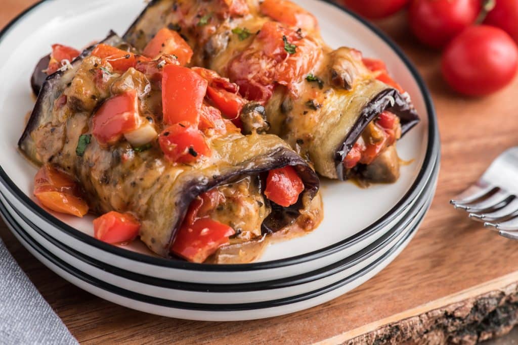 Eggplant rollups on a white plate.