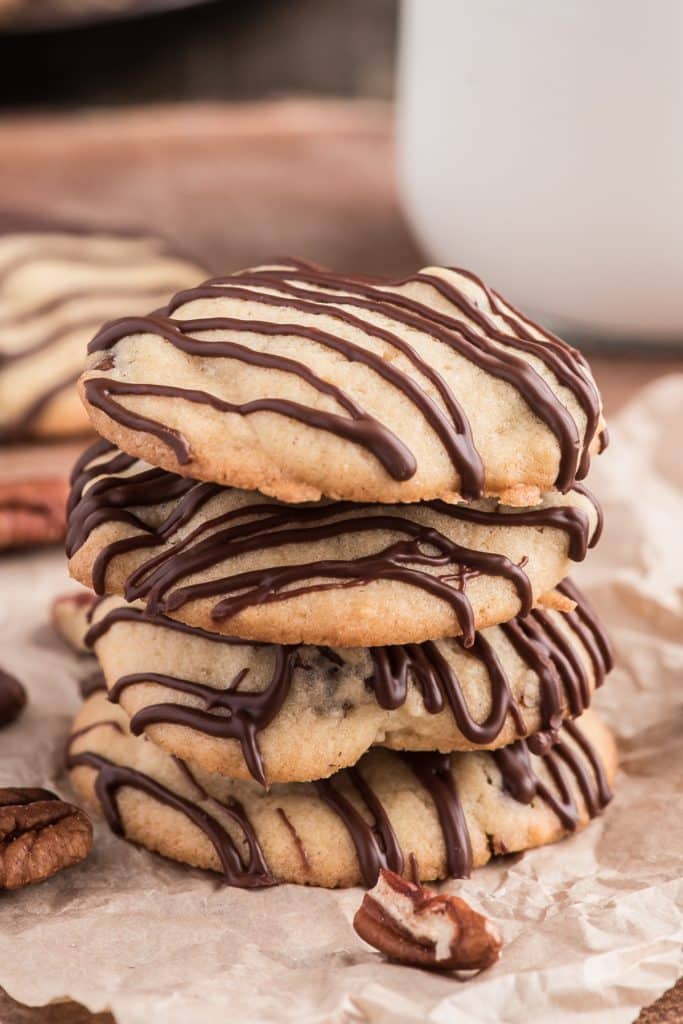 3 stacked cookies drizzled with chocolate.