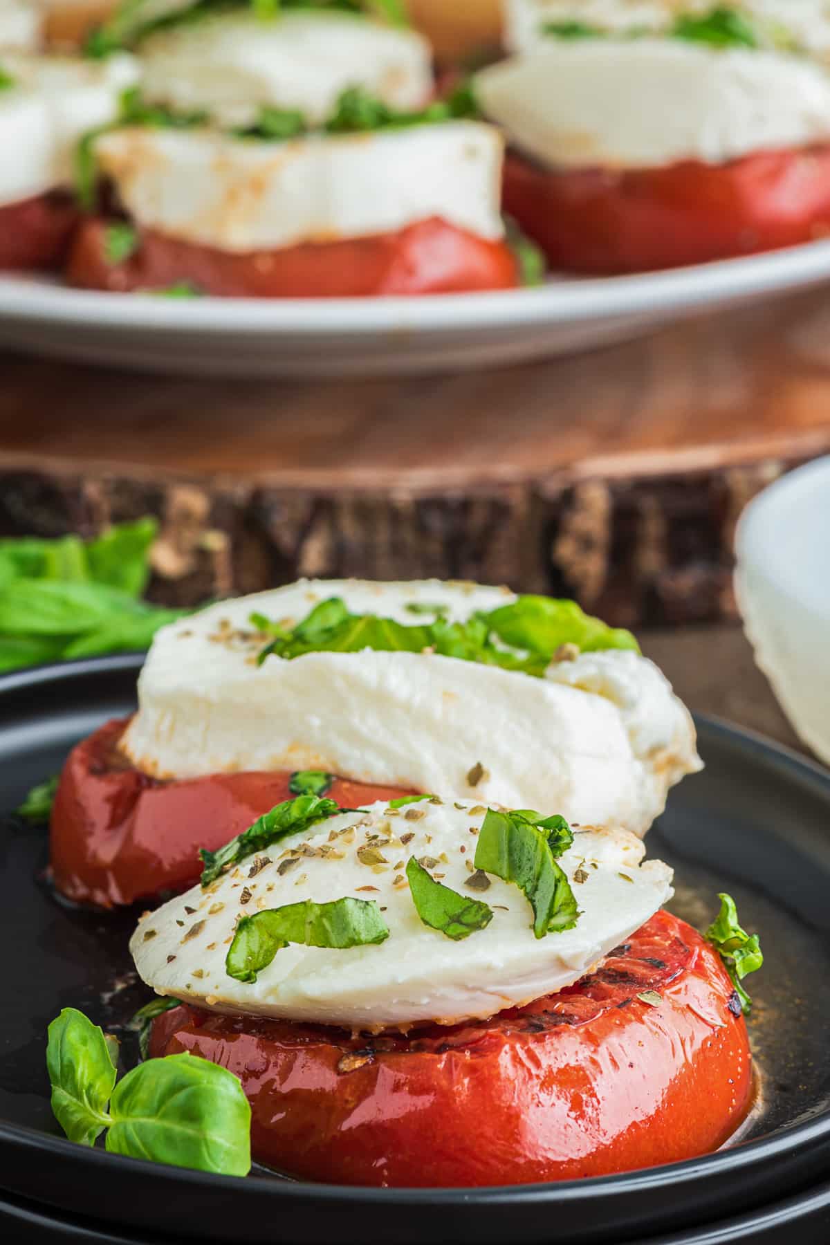 Tomatoes on a plate and some on a big plate.