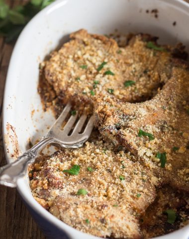 baked pork chops in a white baking dish