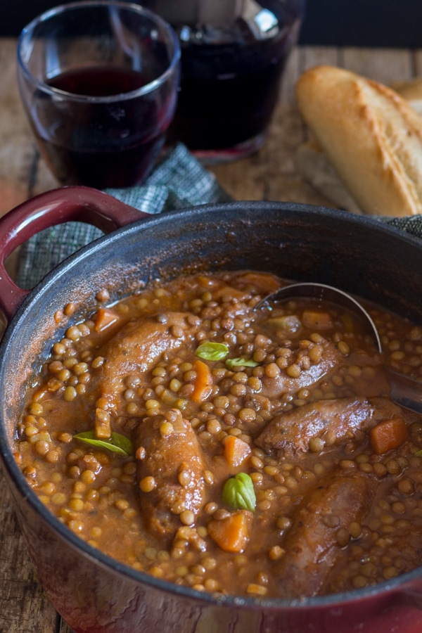 lentils sausage stew in a red pot