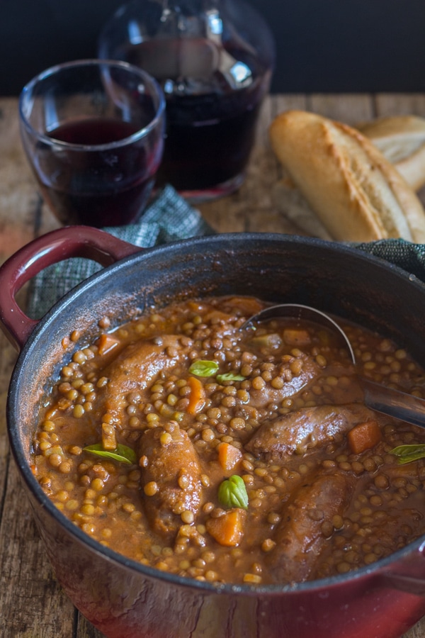 lentils sausage stew in a red pot