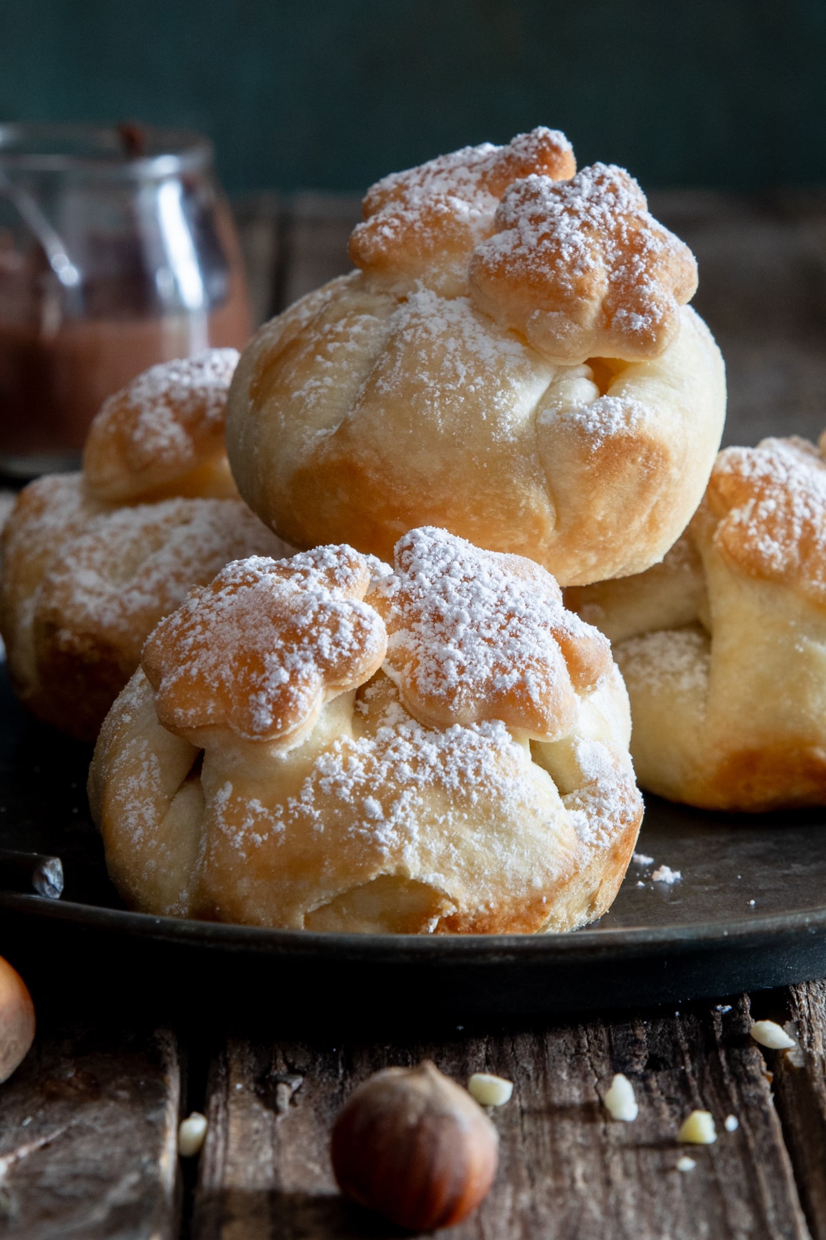 Puff pastry nutella balls on a black tray.