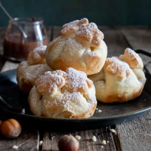 Puff pastry nutella balls on a black tray.