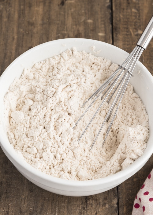 The dry ingredients whisked in a white bowl.