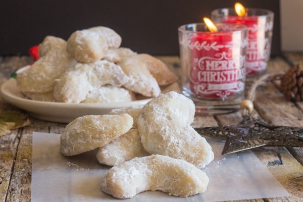 almond crescents on a plate and on white paper