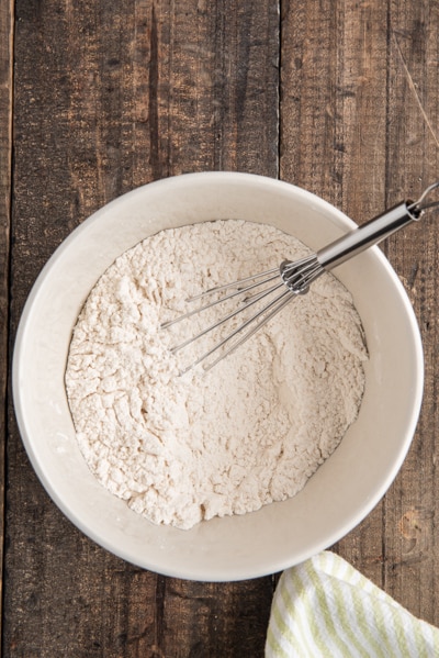 The dry ingredients whisked in a white bowl.