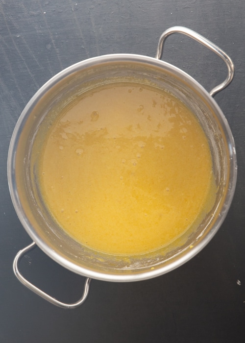 The egg yolk mixture mixed in a silver pot.