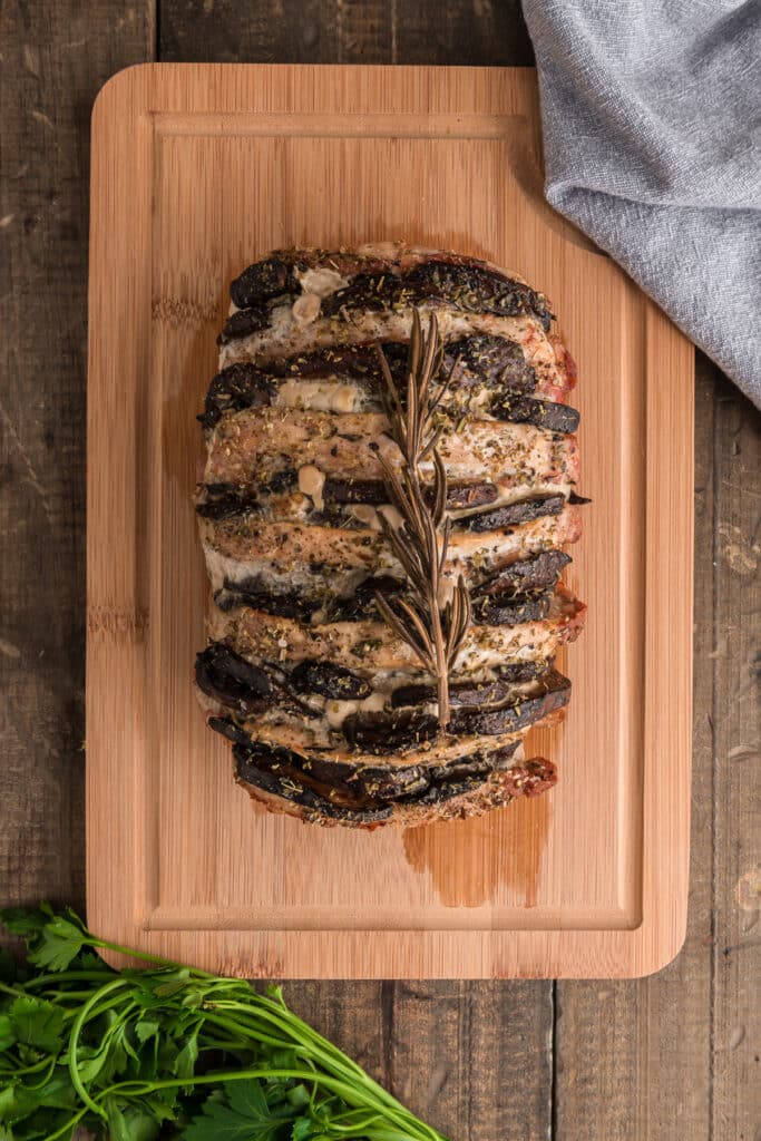 Roast pork on a wooden board.