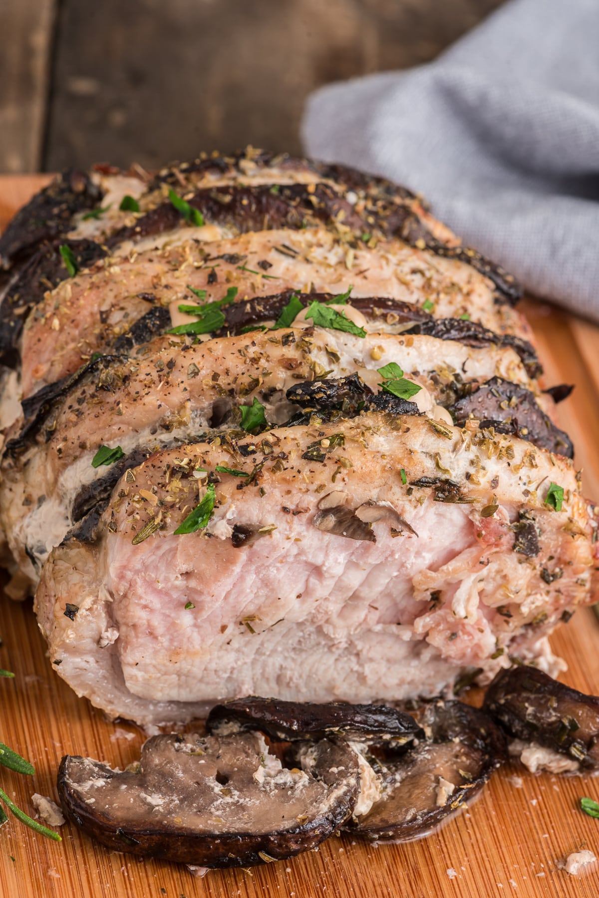 Hasselback pork on a wooden board.