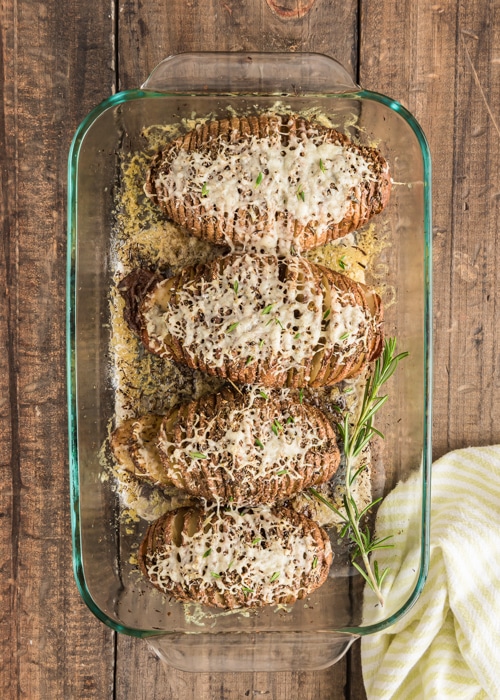 The baked potatoes in a glass dish.