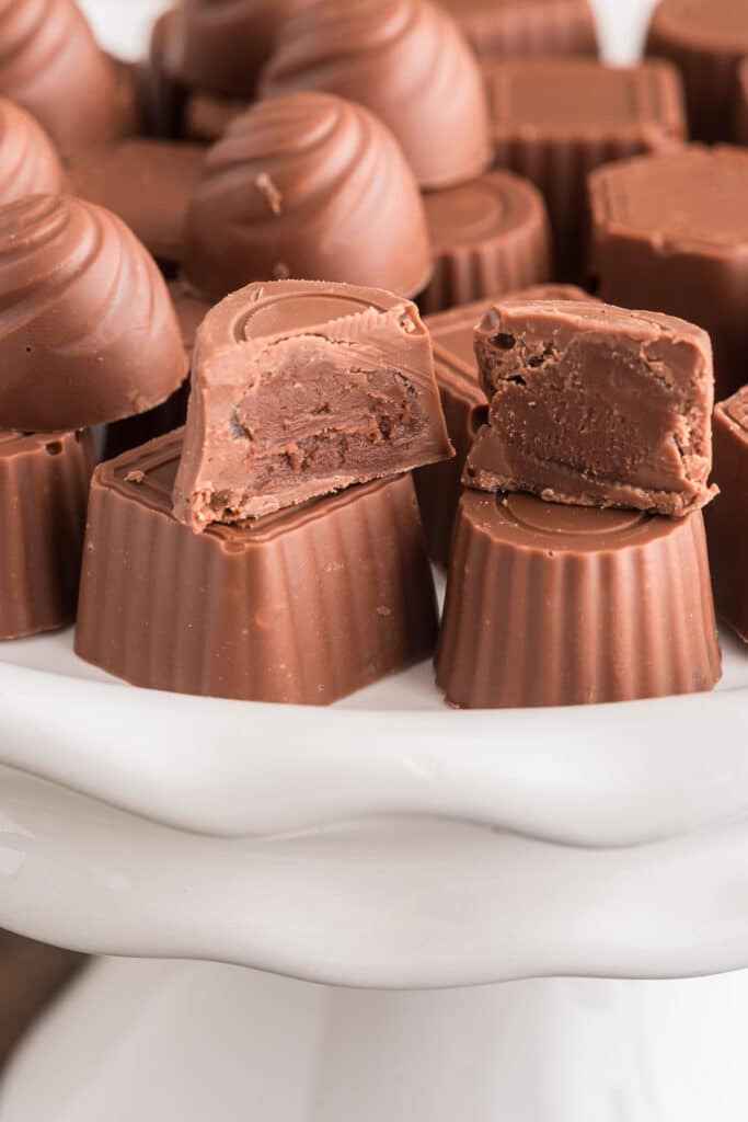 Chocolate on a white plate with a chocolate cut in half.