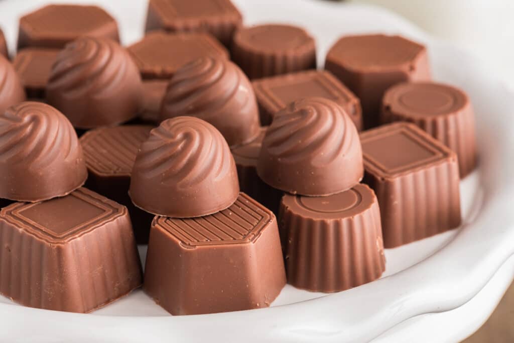 Chocolate mints on a white plate.